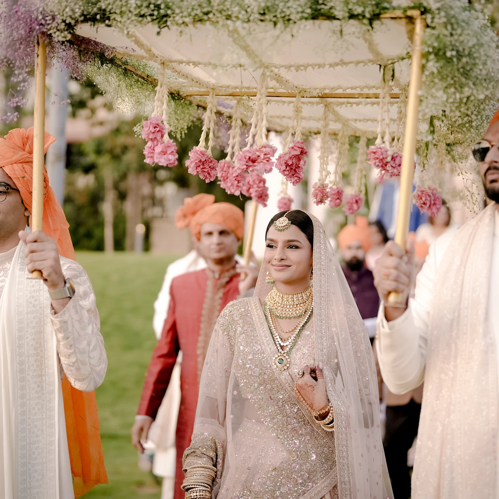 Baraat under a floral canopy