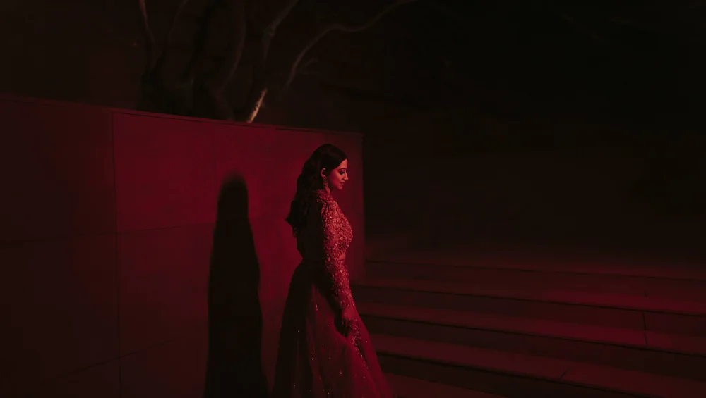 Bride on the stairs in a red lehenga