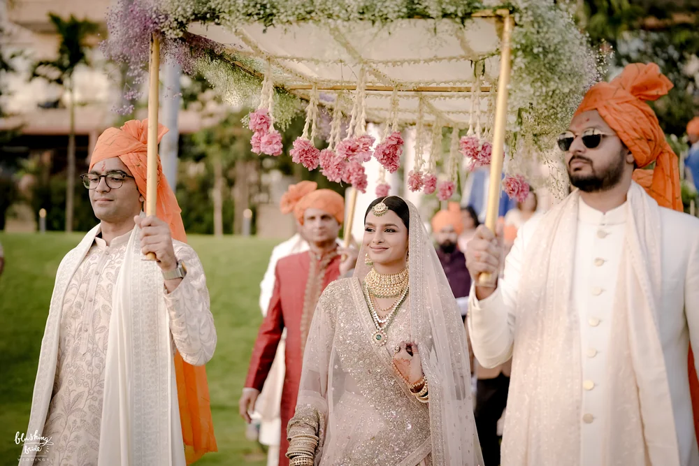 Baraat under a floral canopy